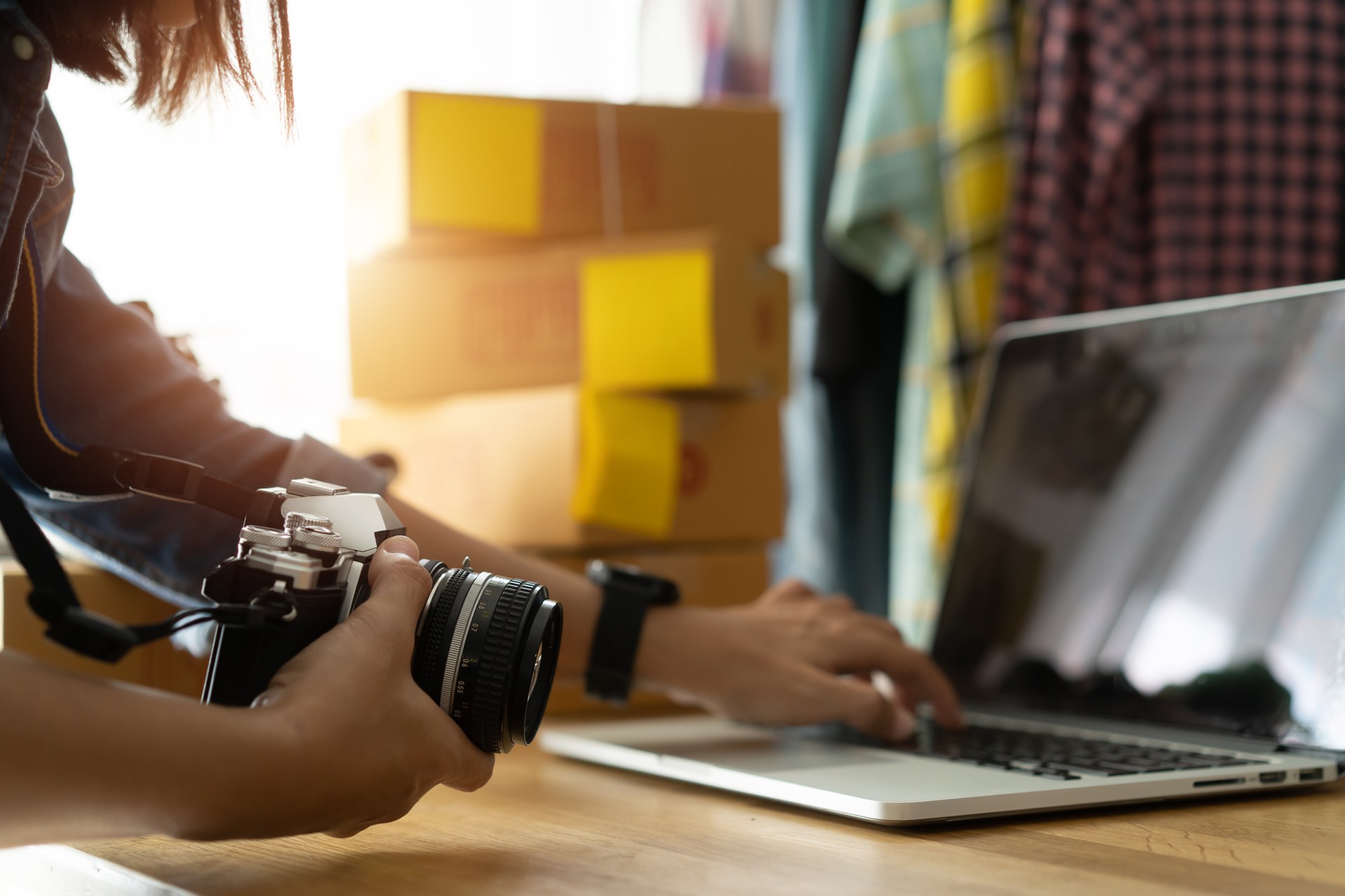 Women business owner working laptop computer selling online, With hold the camera